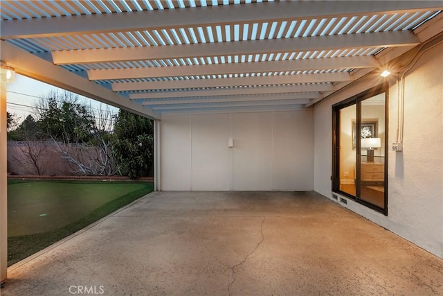 patio terrace at dusk featuring a pergola