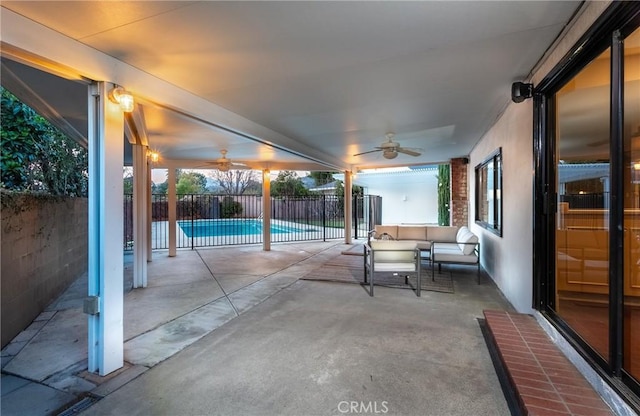 view of patio / terrace featuring ceiling fan, outdoor lounge area, and a fenced in pool