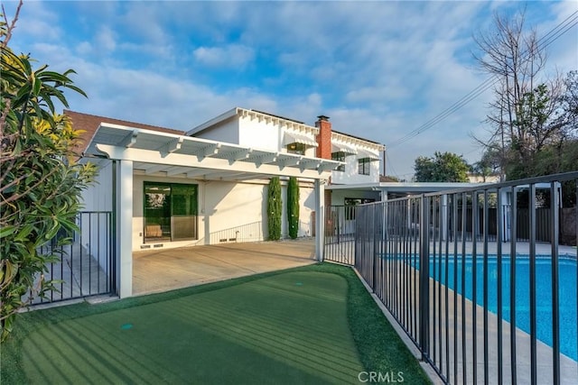 exterior space featuring a fenced in pool, a patio, and a pergola