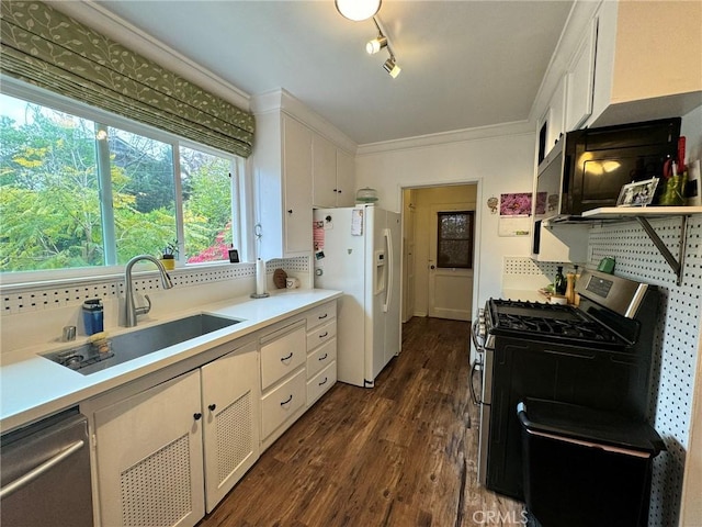 kitchen featuring white cabinetry, appliances with stainless steel finishes, dark hardwood / wood-style flooring, and sink