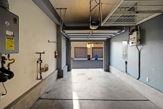 garage with a garage door opener and electric panel