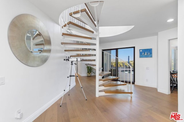 stairway featuring hardwood / wood-style floors