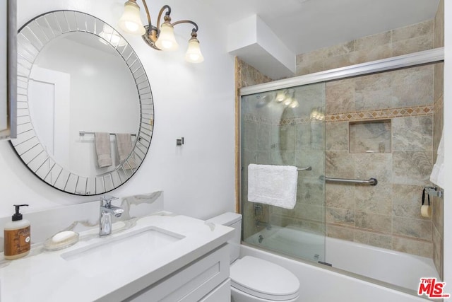 full bathroom with vanity, toilet, and combined bath / shower with glass door