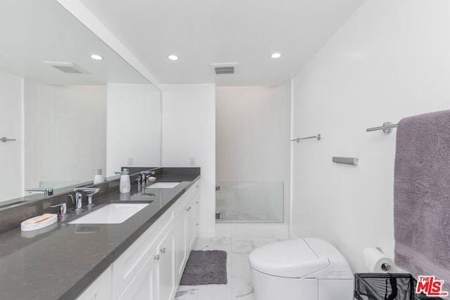 bathroom featuring vanity, toilet, and walk in shower