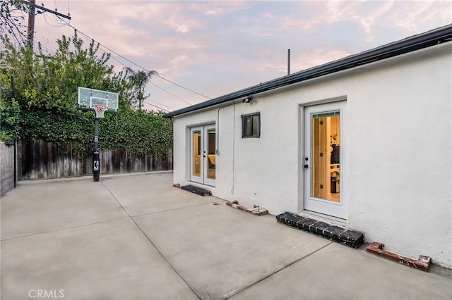 patio terrace at dusk featuring french doors