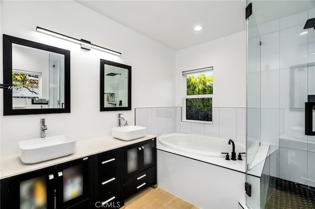 bathroom featuring vanity and plus walk in shower