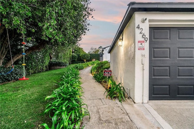 property exterior at dusk with a yard