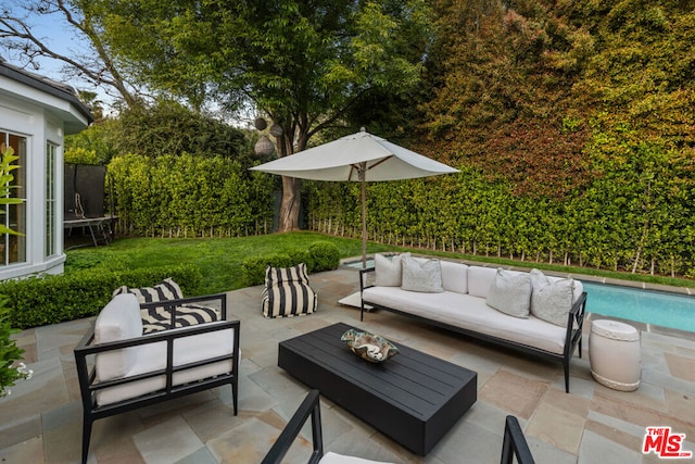 view of patio / terrace with an outdoor living space and a trampoline