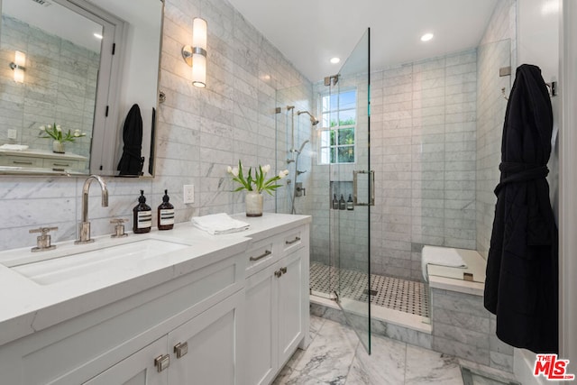 bathroom with walk in shower, decorative backsplash, vanity, and tile walls