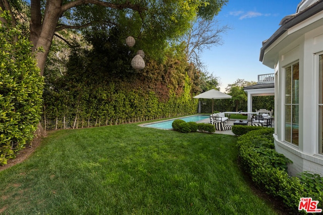 view of yard with a balcony and a patio area