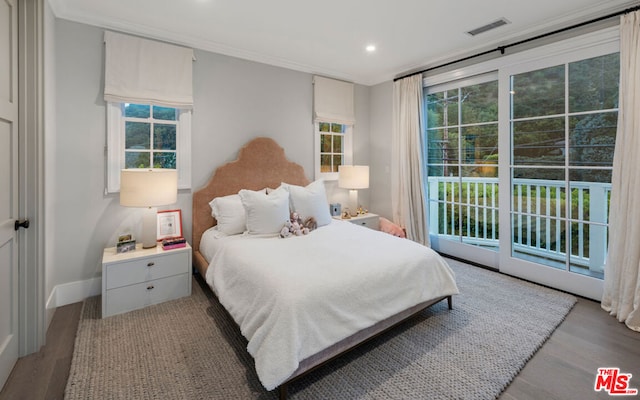 bedroom with multiple windows, ornamental molding, access to outside, and light wood-type flooring