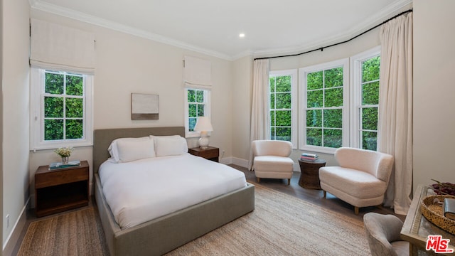 bedroom featuring hardwood / wood-style flooring and ornamental molding