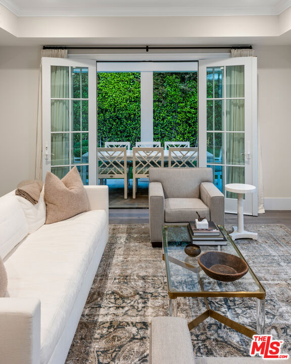 living room featuring crown molding and hardwood / wood-style floors