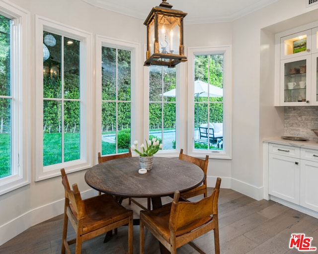 dining room featuring dark hardwood / wood-style flooring and ornamental molding