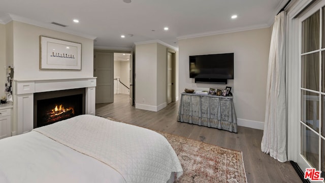 bedroom with crown molding and hardwood / wood-style flooring