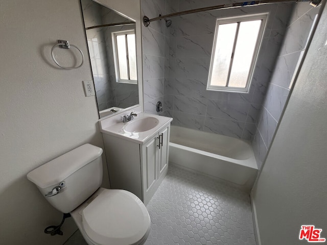 full bathroom with plenty of natural light, toilet, tiled shower / bath combo, and vanity