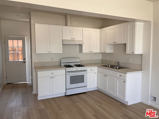 kitchen with white cabinetry, white range with gas cooktop, sink, and light wood-type flooring