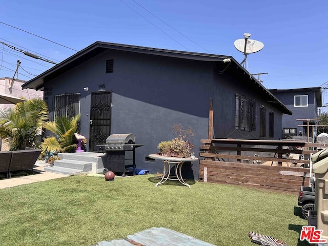 view of side of home featuring a yard