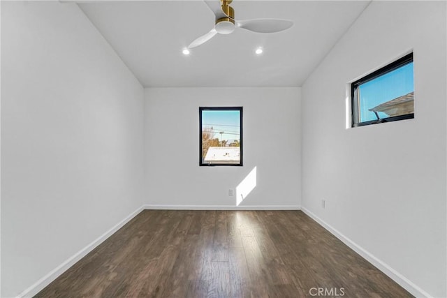 spare room featuring dark hardwood / wood-style flooring, plenty of natural light, and ceiling fan