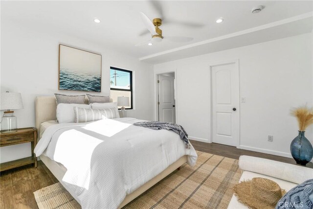 bedroom with ceiling fan and dark hardwood / wood-style floors