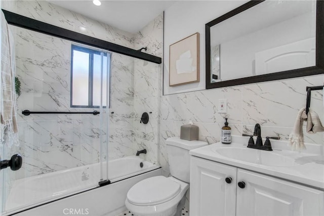 full bathroom featuring tile walls, decorative backsplash, enclosed tub / shower combo, vanity, and toilet