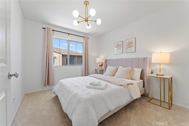 carpeted bedroom featuring an inviting chandelier