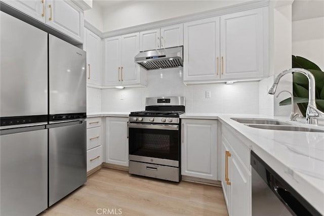 kitchen featuring stainless steel appliances, sink, light hardwood / wood-style flooring, and white cabinets