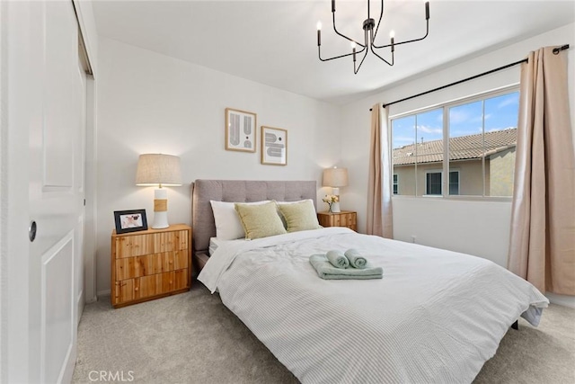 bedroom with light carpet and a notable chandelier