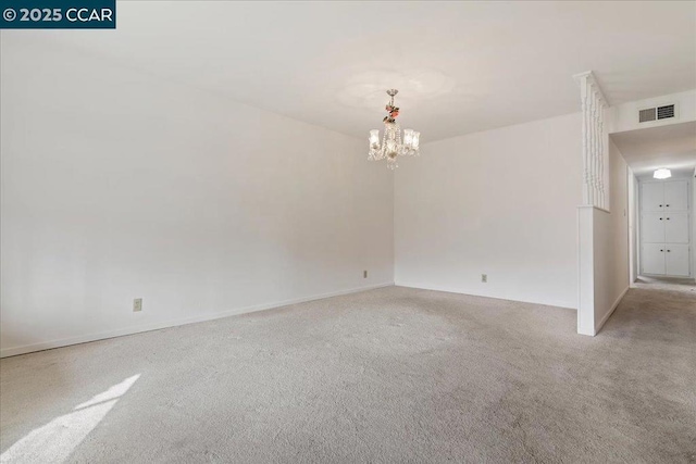 unfurnished room with a notable chandelier and light colored carpet