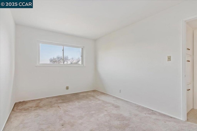 empty room with light colored carpet