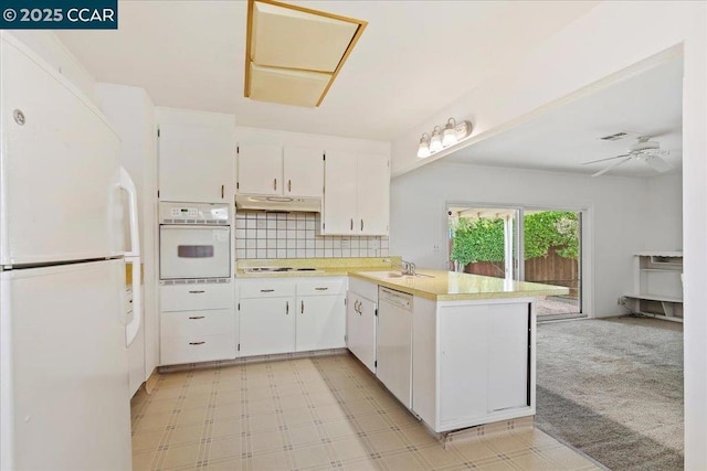 kitchen with white cabinetry, sink, white appliances, and kitchen peninsula