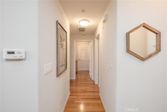 hall with light wood-type flooring