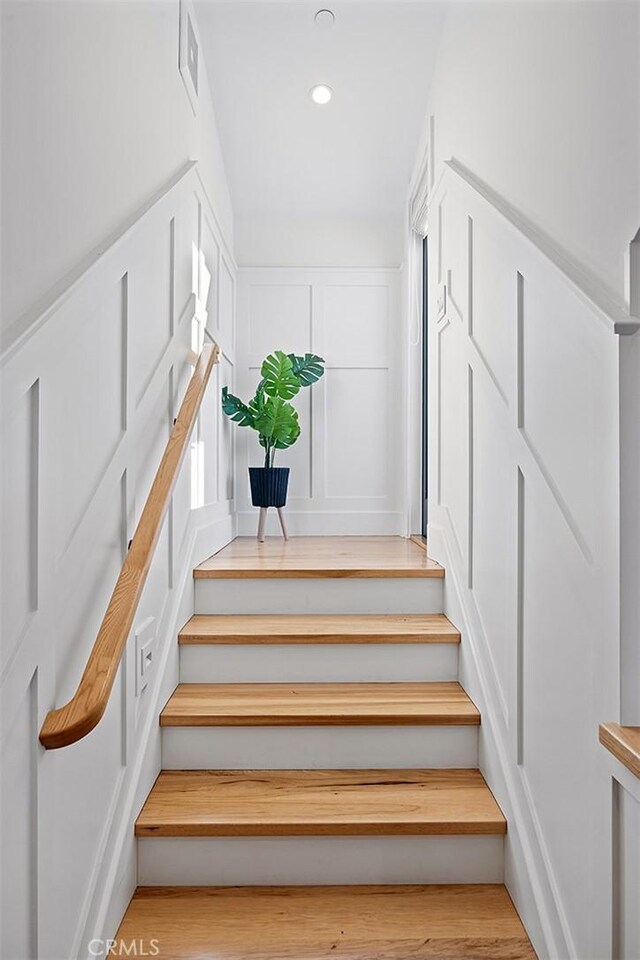 stairway with hardwood / wood-style flooring