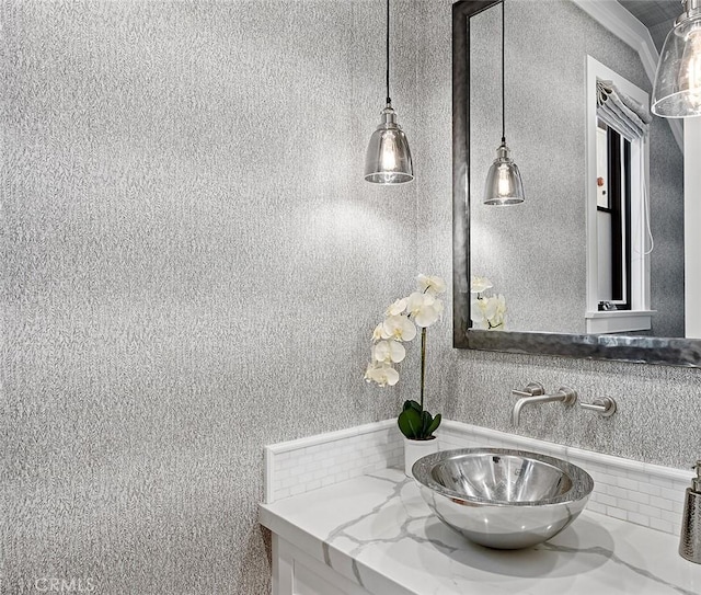 bathroom with vanity and ornamental molding