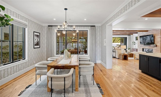 dining area featuring light wood-type flooring, wallpapered walls, baseboards, and ornamental molding