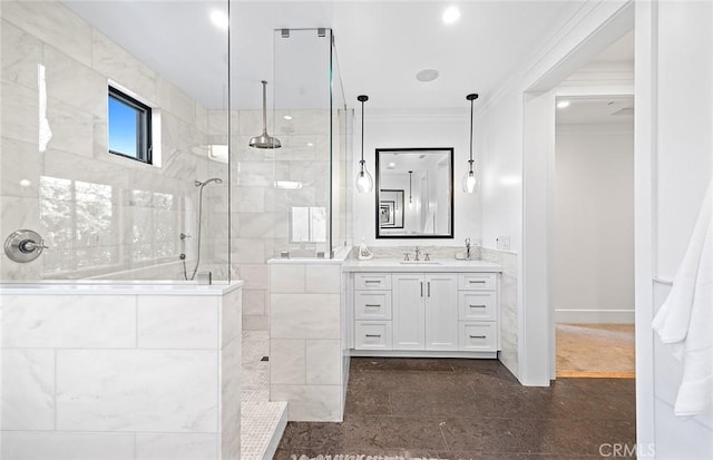 bathroom featuring crown molding, vanity, and a tile shower