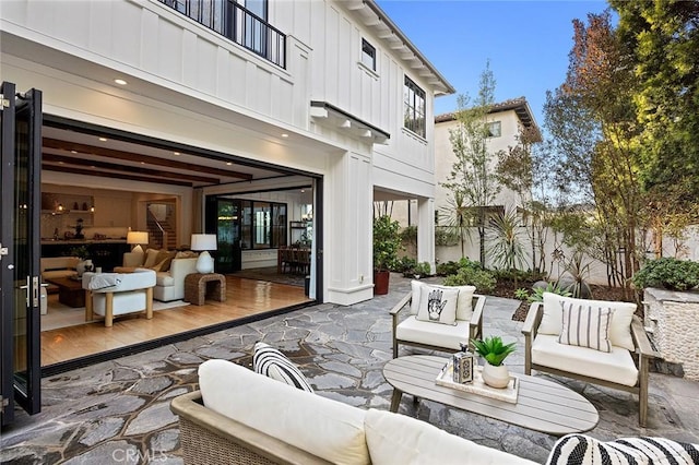 view of patio featuring a balcony and an outdoor hangout area