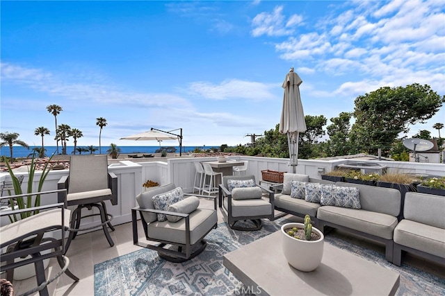 view of patio featuring a water view and outdoor lounge area