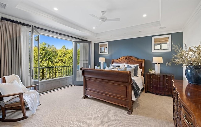 carpeted bedroom featuring ceiling fan, ornamental molding, a tray ceiling, and access to outside