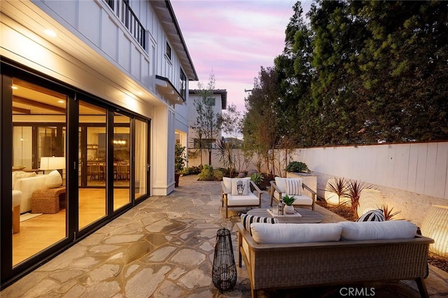 patio terrace at dusk featuring outdoor lounge area