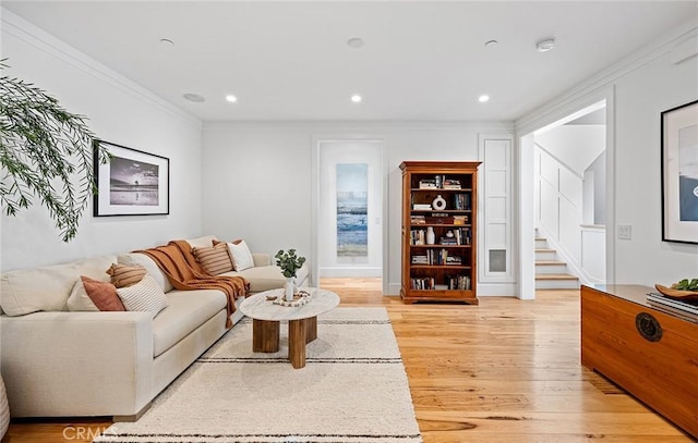 living room featuring crown molding and light wood-type flooring