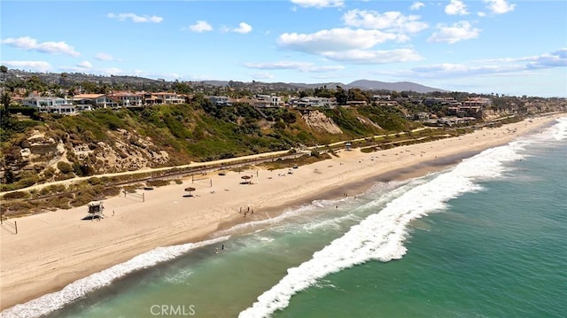 drone / aerial view with a beach view and a water view