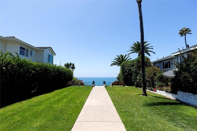 surrounding community featuring a water view and a yard