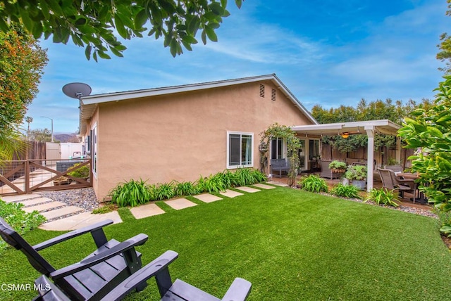 back of house featuring a yard and a patio area