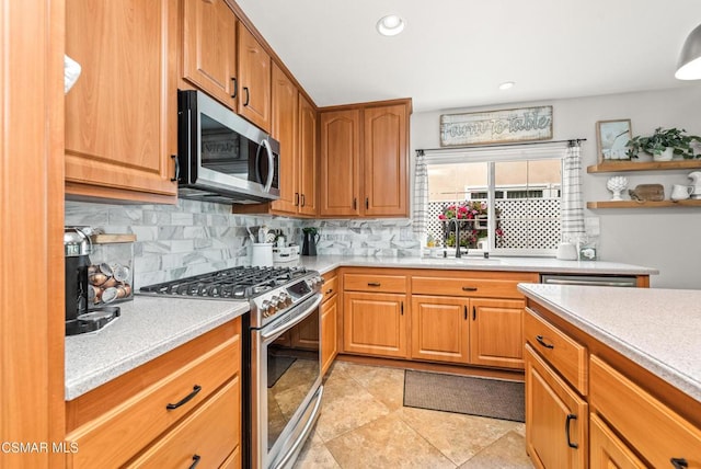 kitchen with stainless steel appliances, sink, light tile patterned floors, and backsplash