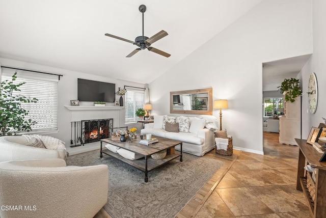 living room with ceiling fan, plenty of natural light, and high vaulted ceiling