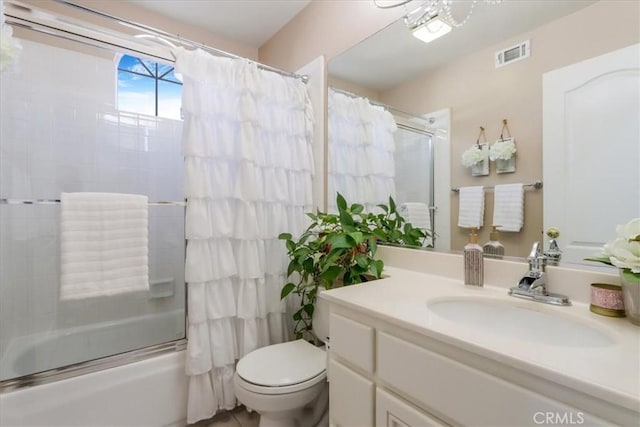 full bathroom featuring vanity, shower / tub combo, and toilet