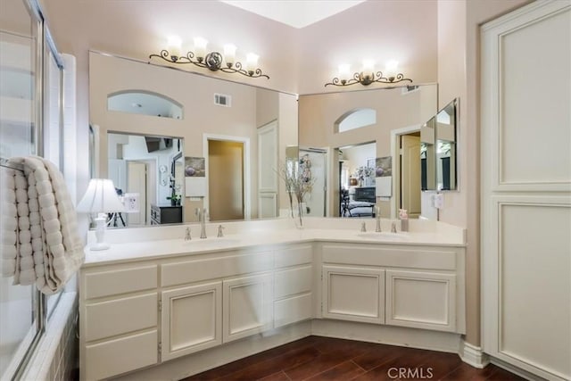 bathroom featuring vanity, an enclosed shower, and hardwood / wood-style floors