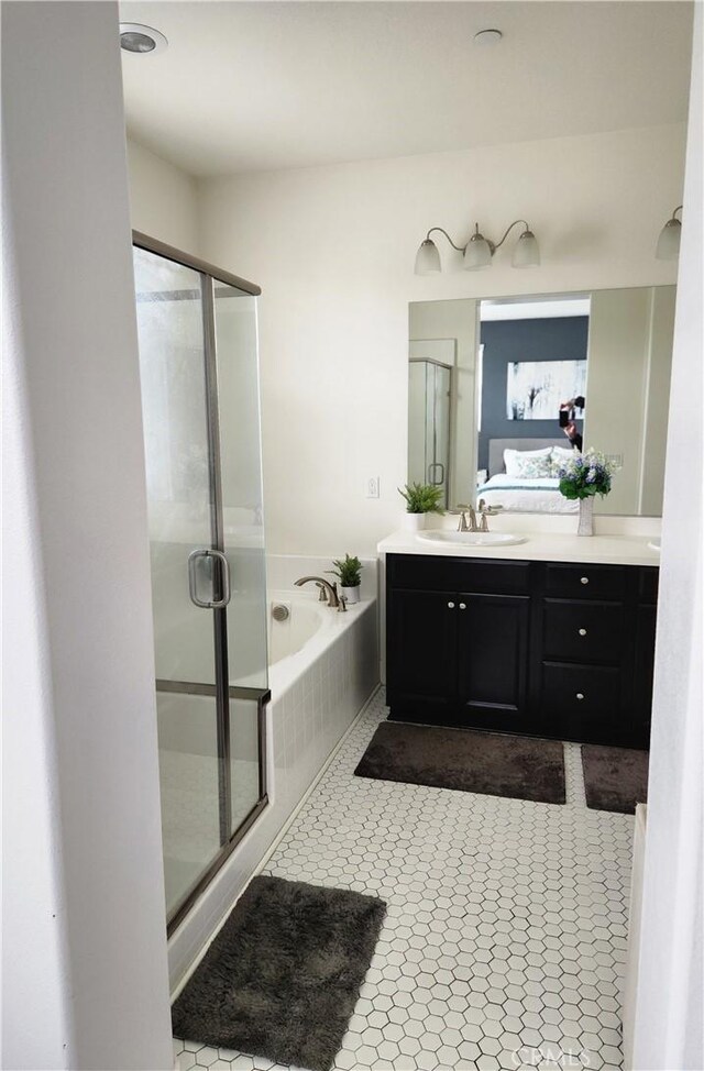 bathroom featuring vanity, separate shower and tub, and tile patterned floors