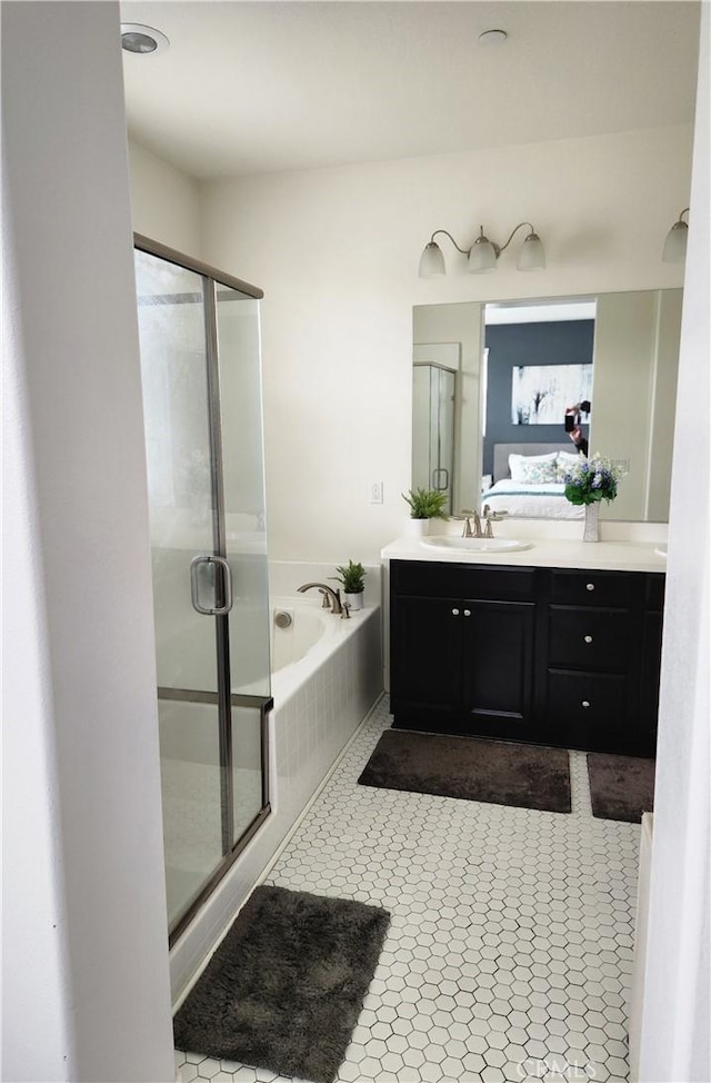 bathroom featuring vanity, tile patterned floors, and shower with separate bathtub